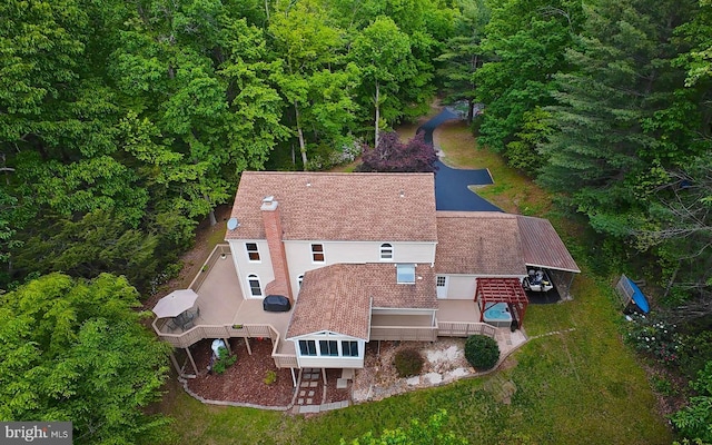 view of subject property with a forest
