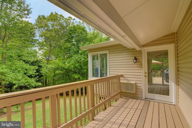 wooden deck with view of scattered trees