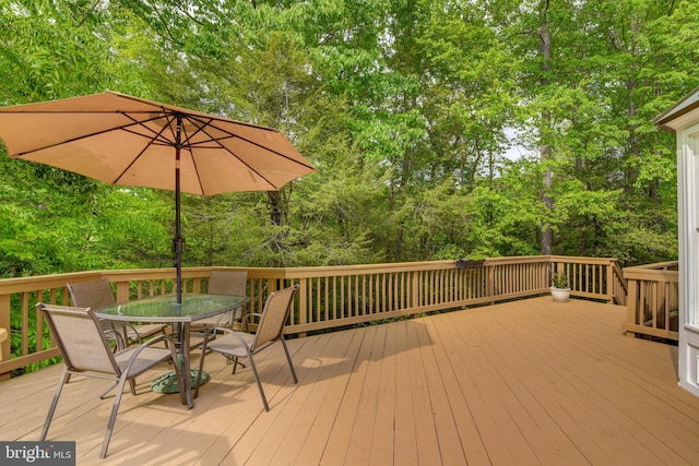 wooden terrace with outdoor dining area