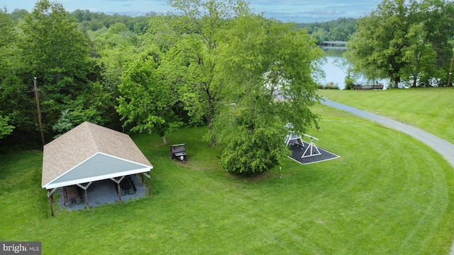 drone / aerial view of a large body of water and a heavily wooded area