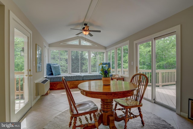 sunroom / solarium with vaulted ceiling, plenty of natural light, and tile patterned floors