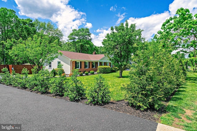 ranch-style home with a chimney