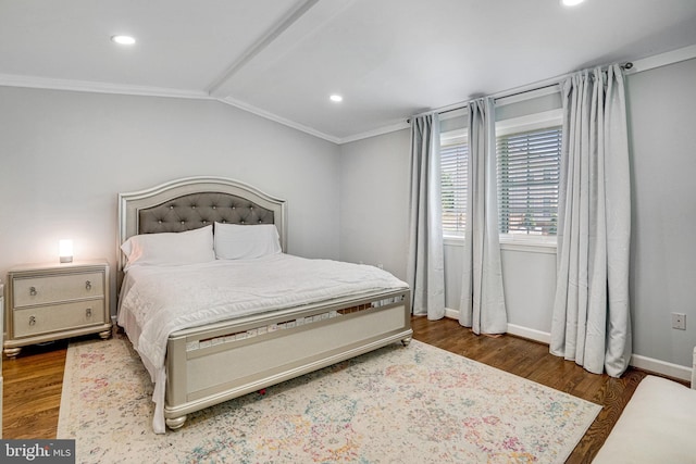 bedroom featuring ornamental molding, wood finished floors, baseboards, recessed lighting, and vaulted ceiling