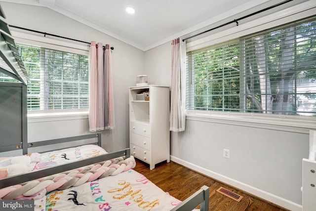 bedroom with multiple windows, wood finished floors, baseboards, and ornamental molding