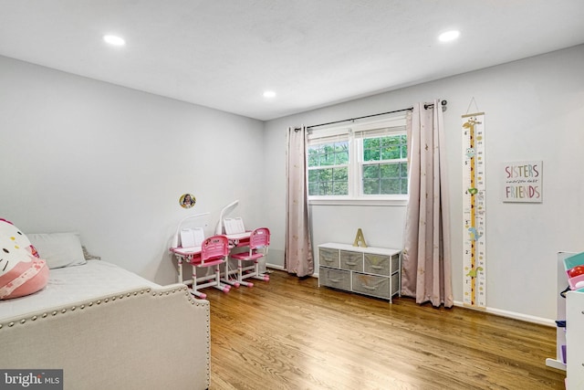 bedroom featuring wood finished floors, recessed lighting, and baseboards