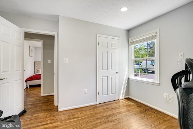 bedroom featuring light wood-type flooring, baseboards, and recessed lighting