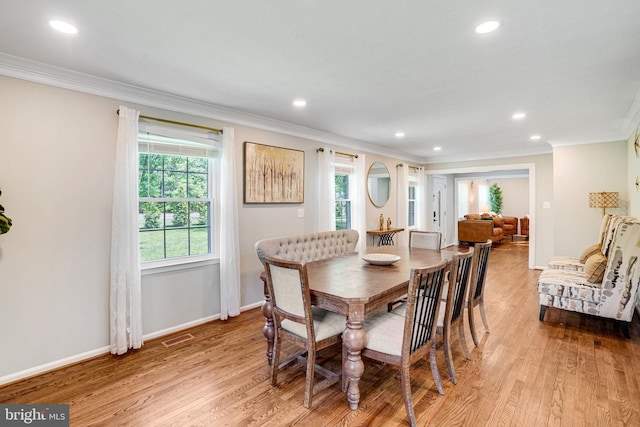 dining room with ornamental molding, wood finished floors, recessed lighting, and baseboards
