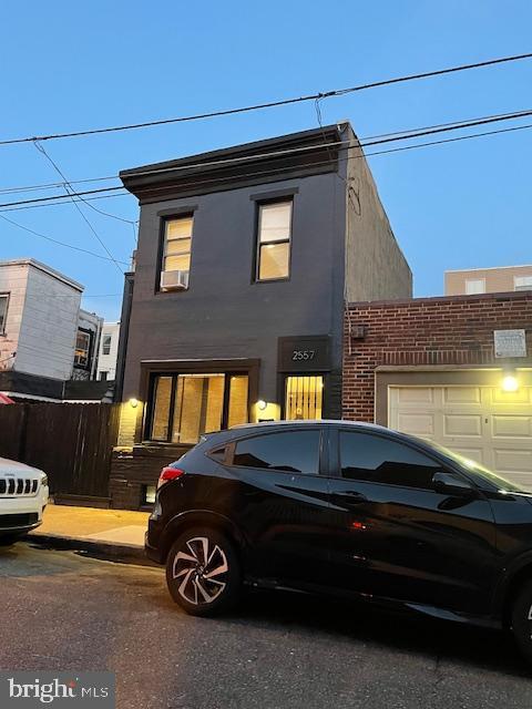 2557 Tilton St, Philadelphia, PA 19125 - view of front of house with stucco siding and a garage