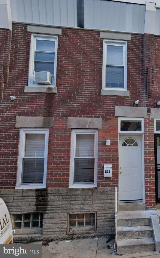 view of front facade featuring stone siding and brick siding
