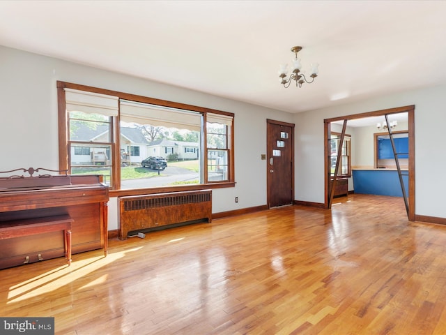 826 W 16th St, Front Royal, VA 22630 - entrance foyer with radiator heating unit, a chandelier, healthy amount of natural light, and wood finished floors