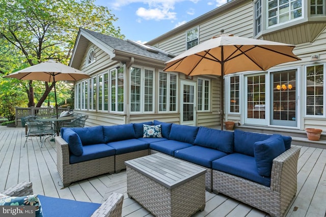 wooden deck with outdoor dining area and outdoor lounge area