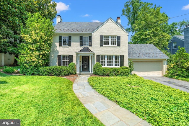 3211 Thornapple St, Chevy Chase, MD 20815 - view of front of home with a high end roof, a chimney, an attached garage, asphalt driveway, and a front yard