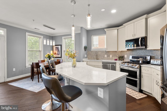 9480 Virginia Center Blvd Unit 239, Vienna, VA 22181 - kitchen with stainless steel appliances, a kitchen island, tasteful backsplash, ornamental molding, and a sink