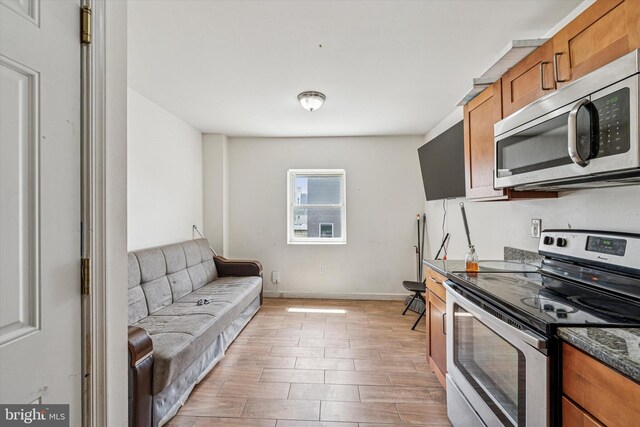 1934 Cecil B Moore Ave, Philadelphia, PA 19121 - kitchen with stainless steel appliances, brown cabinets, baseboards, and light wood finished floors