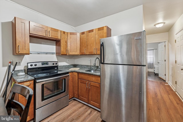 1934 Cecil B Moore Ave, Philadelphia, PA 19121 - kitchen with appliances with stainless steel finishes, a sink, light wood finished floors, and brown cabinets