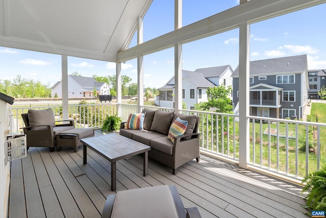 sunroom / solarium with an outdoor living space, a residential view, and vaulted ceiling