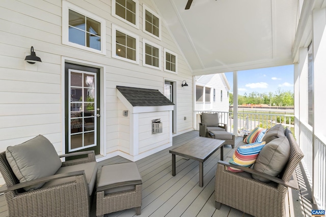 wooden terrace with an outdoor living space