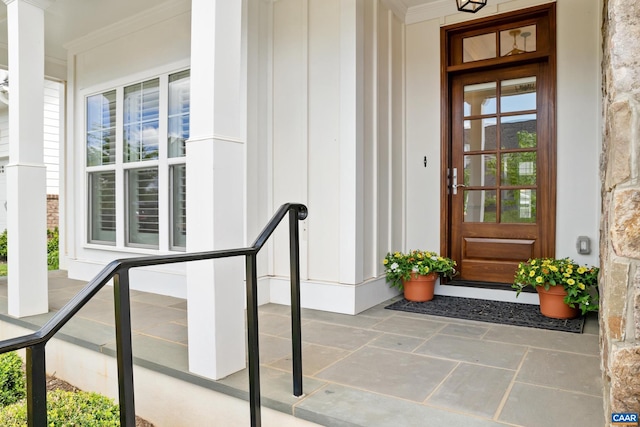 doorway to property featuring covered porch and board and batten siding