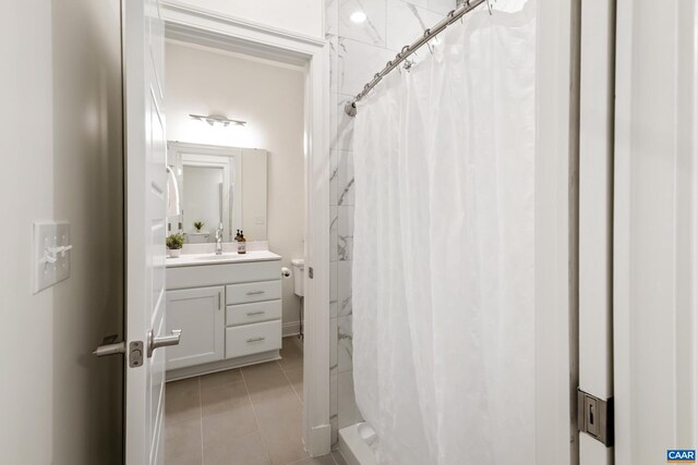 bathroom with tile patterned floors, vanity, curtained shower, and toilet