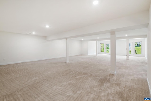 basement featuring recessed lighting, light colored carpet, and baseboards