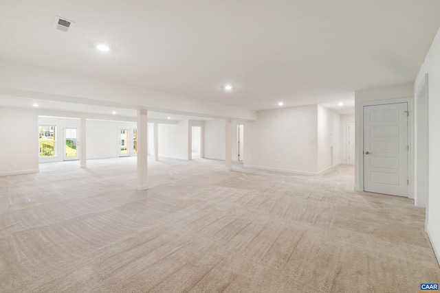 unfurnished living room featuring recessed lighting, light carpet, and baseboards