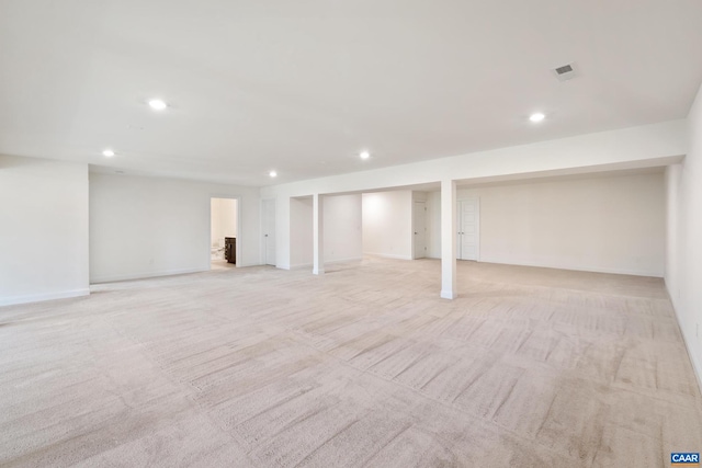 finished basement featuring light carpet, recessed lighting, and baseboards