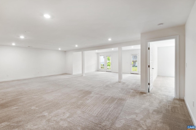 below grade area with light colored carpet, recessed lighting, and baseboards