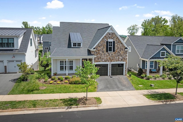craftsman-style house featuring asphalt driveway, covered porch, board and batten siding, and stone siding