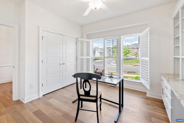 office featuring light wood-style floors, plenty of natural light, baseboards, and ceiling fan