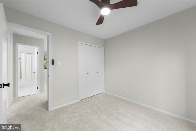 unfurnished bedroom featuring carpet, baseboards, a closet, and a ceiling fan