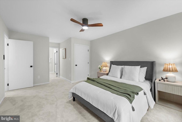 bedroom featuring carpet, baseboards, a ceiling fan, and connected bathroom