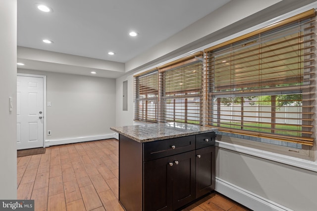 9 Queens Bridge Rd, Levittown, PA 19057 - kitchen with light stone counters, baseboards, light wood finished floors, recessed lighting, and a peninsula