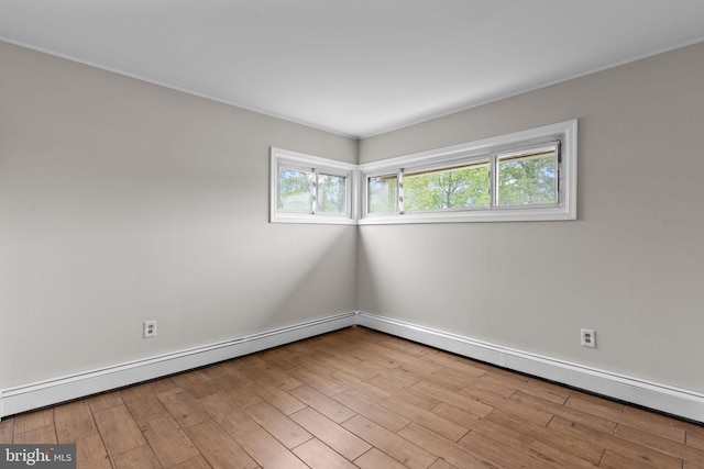 9 Queens Bridge Rd, Levittown, PA 19057 - empty room with baseboards, wood finished floors, and a baseboard heating unit