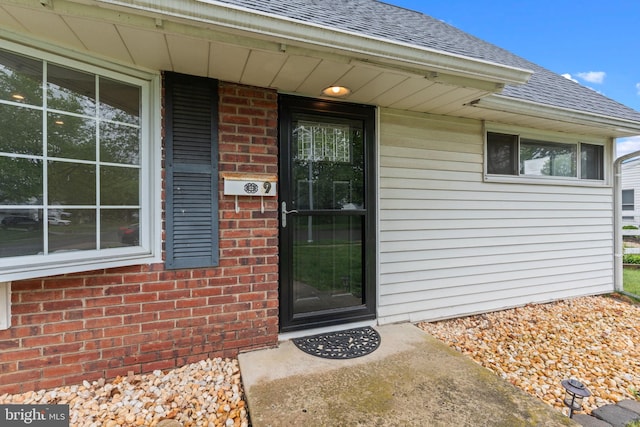 9 Queens Bridge Rd, Levittown, PA 19057 - property entrance with roof with shingles and brick siding