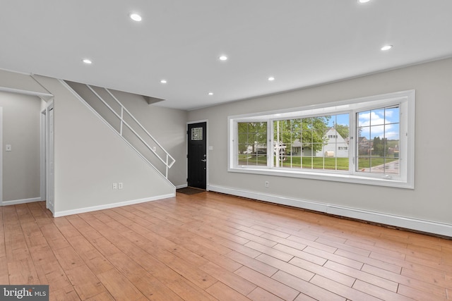 9 Queens Bridge Rd, Levittown, PA 19057 - unfurnished living room with stairway, recessed lighting, light wood-style floors, and baseboards