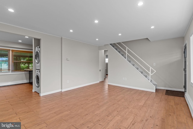 9 Queens Bridge Rd, Levittown, PA 19057 - unfurnished living room featuring stacked washing machine and dryer, stairs, baseboards, light wood-type flooring, and recessed lighting