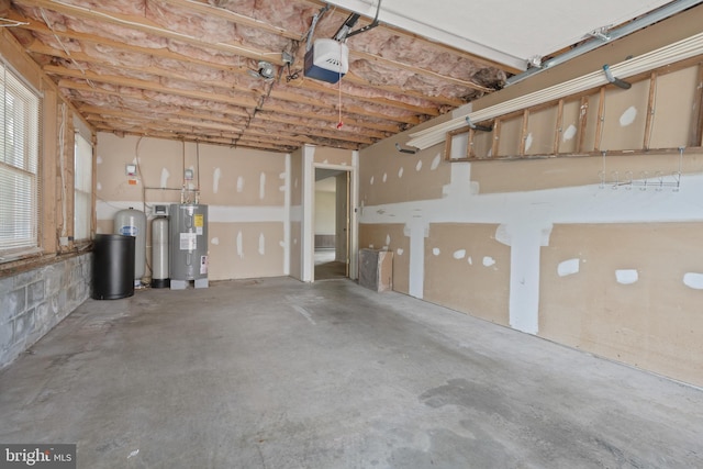 garage with electric water heater and a garage door opener