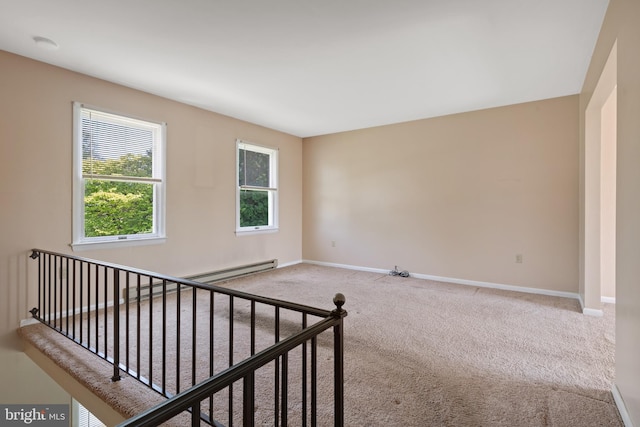 spare room with carpet floors, baseboards, and a smoke detector