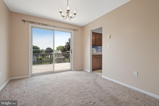 unfurnished room featuring a chandelier, light carpet, and baseboards
