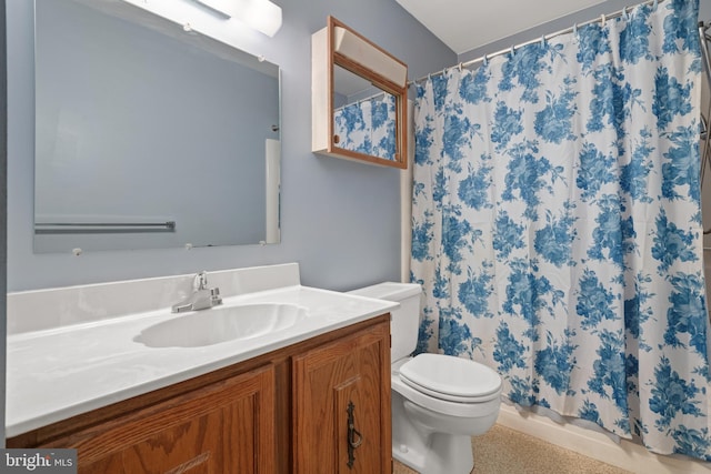 bathroom featuring toilet, vanity, and a shower with shower curtain