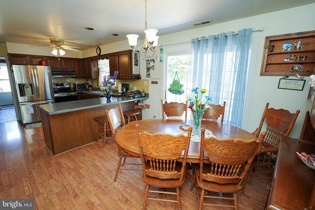 117 Mimosa Dr, Cambridge, MD 21613 - dining space featuring light wood-style flooring, ceiling fan, and a chandelier