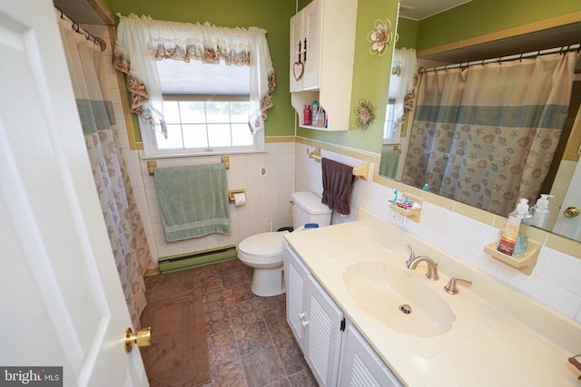 117 Mimosa Dr, Cambridge, MD 21613 - bathroom featuring baseboard heating, tile walls, toilet, vanity, and wainscoting