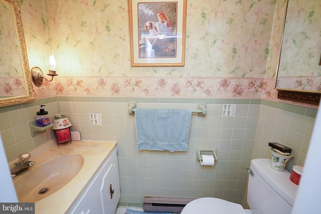 117 Mimosa Dr, Cambridge, MD 21613 - bathroom featuring wallpapered walls, tile walls, a wainscoted wall, toilet, and baseboard heating