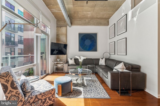 living room with wood finished floors and baseboards