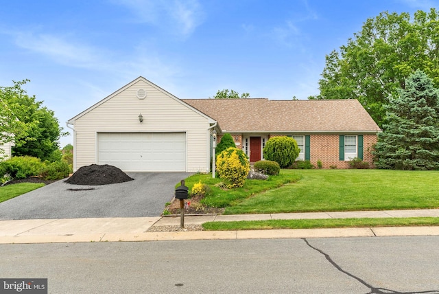 3135 Windon Ave, Lancaster, PA 17603 - single story home featuring asphalt driveway, a garage, a front lawn, and brick siding