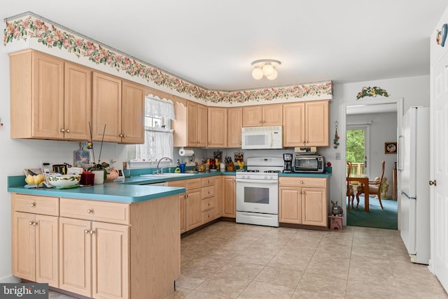 3135 Windon Ave, Lancaster, PA 17603 - kitchen with white appliances, light brown cabinetry, plenty of natural light, and a sink