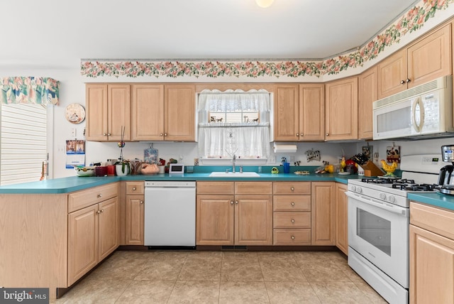 3135 Windon Ave, Lancaster, PA 17603 - kitchen with white appliances, a sink, light brown cabinetry, and a peninsula