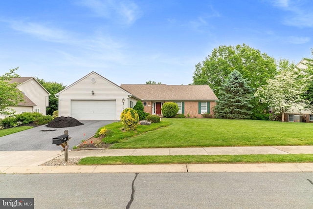 3135 Windon Ave, Lancaster, PA 17603 - view of front of home with driveway, an attached garage, a front lawn, and brick siding