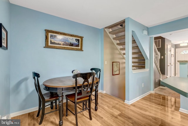 9568 Buttonbush Ct, Manassas, VA 20110 - dining room featuring stairway, light wood-style flooring, and baseboards