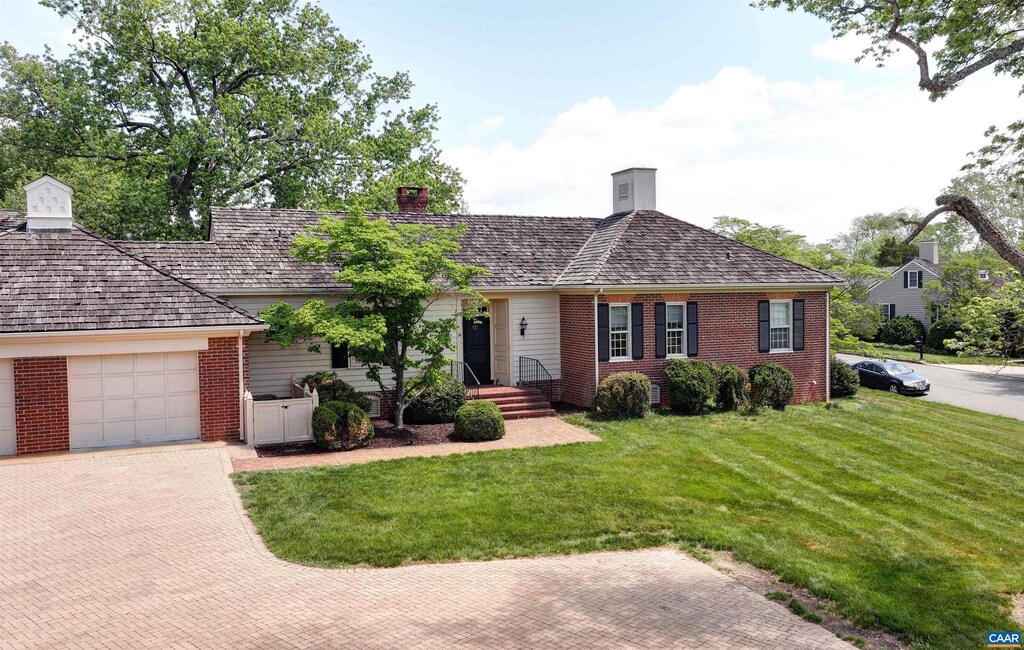 14 Ednam Village St, Charlottesville, VA 22903 - view of front facade featuring brick siding, a front lawn, decorative driveway, a garage, and a chimney